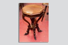 A rosewood hexagonal topped sewing/work table, the hinged top opening to reveal a multi-