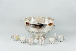 A nice quality punch bowl with wavy gadrooned lip, lion's mask ring handles, a floral embossed