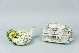 A bullet shaped Quimper teapot having floral decoration and double serpent handle and with knopped