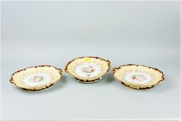 A pair of 19th Century Staffordshire china low pedestal comports in the Rockingham style with yellow