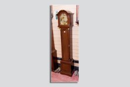 A good quality early 20th Century brass faced grandmother clock, triple weight chiming movement with