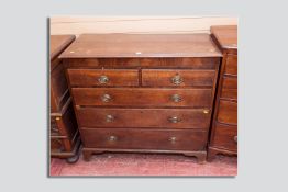 An early 19th Century oak and mahogany crossbanded chest of drawers, a twin plank moulded top over a