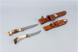 Two Bowie style hunting knives with horn handles and in leather sheaths, one marked 'Morseth'
