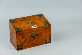 A burr walnut lidded stationery box decorated with Gothic style metal mounts and escutcheon, the lid
