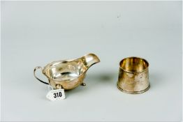 A plain silver sauce boat on three hoof supports, 3.3 ozs, Sheffield 1959 and a circular plain