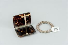 A white metal filigree ball bangle and a small tortoiseshell lidded box