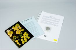 A salvaged 'pieces of eight' coin from HMS Association which sank in the year 1707 along with a