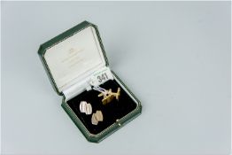 A pair of eighteen carat gold two tone oblong cufflinks, 12.5 grms and a pair of unmarked white