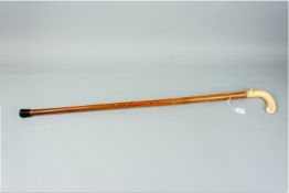 A carved handled walking cane depicting a bird of prey with its kill and a carved belt and buckle