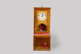 A Gensign clocking-in time recorder in an oak case with a single glass door, the painted white
