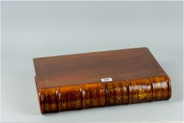 A 20th Century hardwood storage box in the form of a book with gilt tooled decoration to the top and