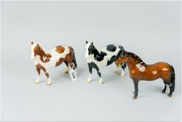 A Beswick brown Dartmoor pony (chips), a Beswick brown and white pinto pony (loss to one ear) and
