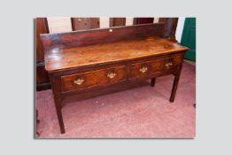 An 18th Century elm top two drawer server with later added back rail, the two planked top over two