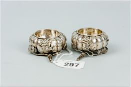 Two, possibly Oriental silver salt pots with applied leaf and floral decoration, 2.4 ozs
