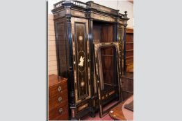 An impressive amboyana and ebonized triple French wardrobe, profusely decorated with ivory and red