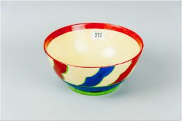 A Clarice Cliff Bizarre bowl, cream ground with rust decorated rim leading down to blue, rust and