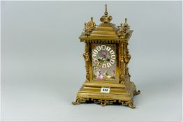 A French brass striking mantel clock, Oriental influence in design, with four corner finials with
