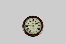 A round late Victorian oak wall clock set with a painted dial having Roman numerals and the