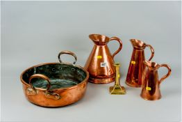 A circular twin handled antique copper cheese/cream pan, a copper beer measure, a pair of
