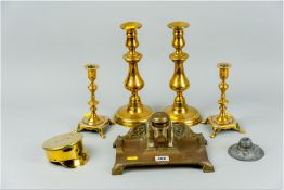 A French repousse brass desk stand having a bevelled glass inkpot with brass lid along with a pair
