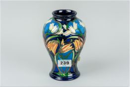 A Moorcroft 'Tulip' vase having a tube lined multi-coloured all over pattern on a deep cobalt blue