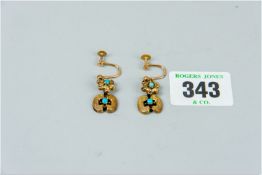 A pair of bright cut yellow metal and turquoise earrings