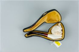 A Meerschaum cased pipe with pseudo ivory bearded gentleman mask bowl