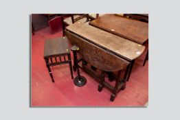 A period oak gate leg table with turned legs and shaped block supports along with a galleried
