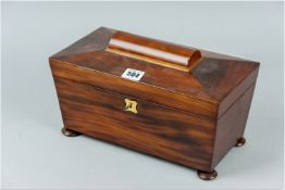 A Victorian mahogany sarcophagus shaped tea caddy, dome topped central panel set upon a four