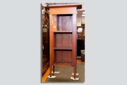 An Arts & Crafts style cabinet/bookcase in the manner of Gustav Stickley, an oversized inverted