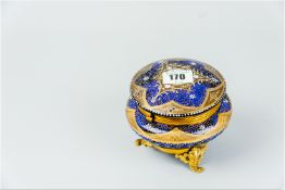 A Bristol blue hinge lidded trinket bowl having gilt metal ring mounts to the glass forming the