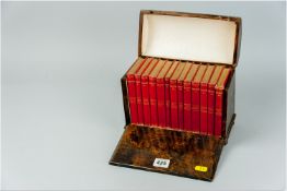 A wooden and papier mache dome topped casket, painted to give the appearance of walnut, the drop