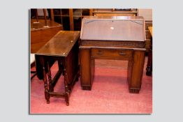 An oak pedestal bureau, the pedestals forming side bookcases along with a turned gate leg table