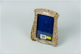 A silver easel portrait frame (damage)