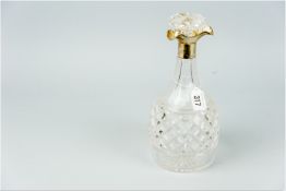 A hobnail cut glass mallet shaped decanter and stopper having a silver collar and incorporated