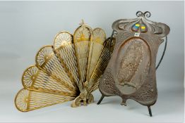 A wrought iron and repousse copper Art Nouveau firescreen, the central oval panel with a high relief