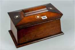 A Victorian sarcophagus shaped tea caddy, the lid with bullseye mother of pearl inlay, walnut