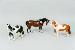A Beswick brown mare (losses to one ear), a black and white pinto pony (restoration to one ear)