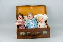 An Armand Marseille bisque headed doll with moveable blue eyes, open mouth and a blonde wig, marks