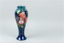 A Moorcroft 'Finches' slender blue ground vase of tapering form with flared neck, tube line