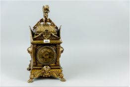 A late 19th Century French brass mantel clock, profusely decorated square case, silvered dial (