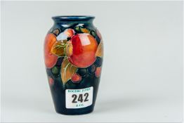 A Moorcroft 'Pomegranate' flared neck vase, deep cobalt ground colour with surrounding tube lined