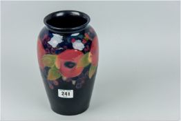 A Moorcroft 'Pomegranate' vase with flared neck, cobalt blue ground with a tube lined pomegranate