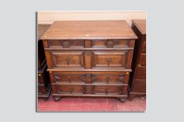 An early Victorian chest of drawers in the Jacobean style in two parts, bullnose top leading down to