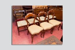 Three Victorian mahogany and upholstered balloon backed chairs, carved backs with carved knee and