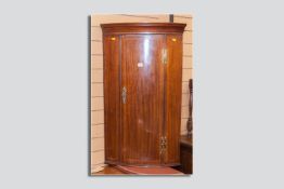 A Georgian mahogany and crossbanded and line inlaid corner cupboard with brass 'H' hinges and a