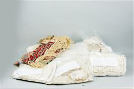 A large parcel of good quality embroidered and crocheted fabric and two paisley shawls