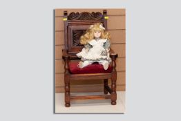 A late 19th Century carved oak child's armchair with carved top rail and carved chamfered back