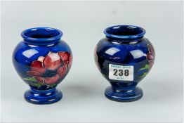 A pair of small Moorcroft 'Anemone' globular shaped vases, deep cobalt blue ground with single