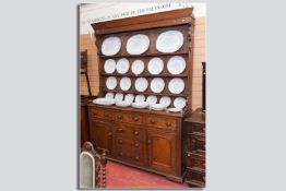 A late Georgian/early Victorian North Wales oak dresser, the shape fronted rack with circular turned